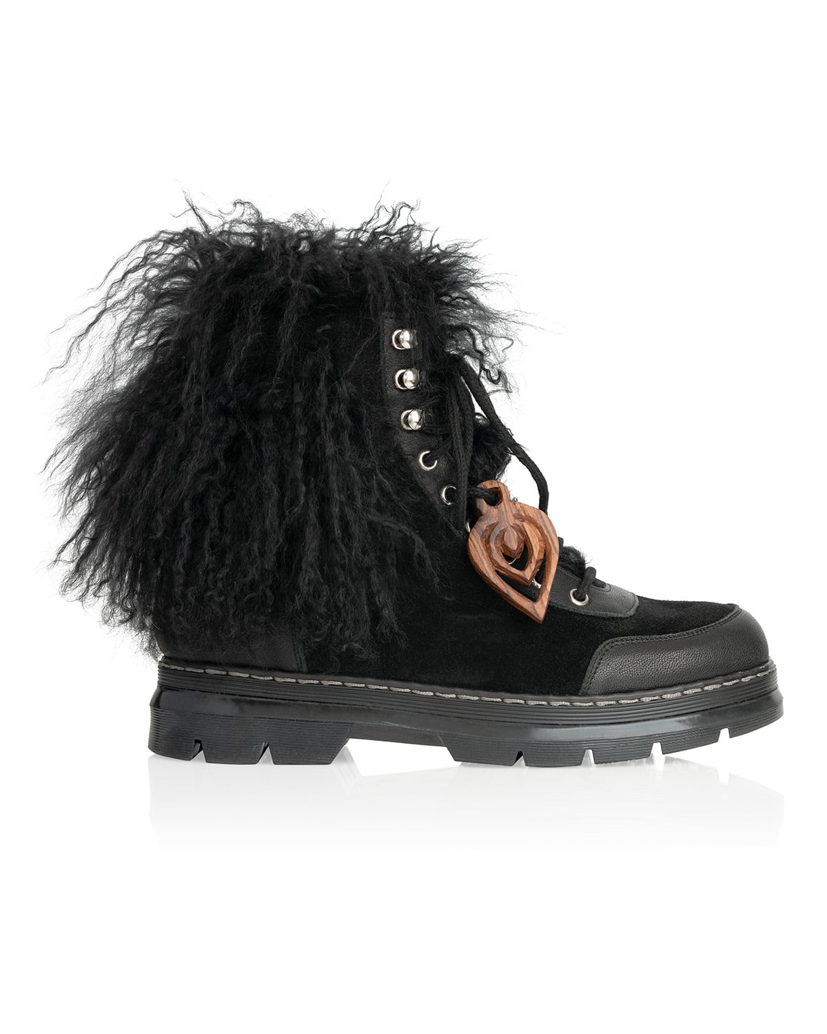 Black combat boot with curly-pile collar and wooden charm. Mixed textures: suede, leather, wood